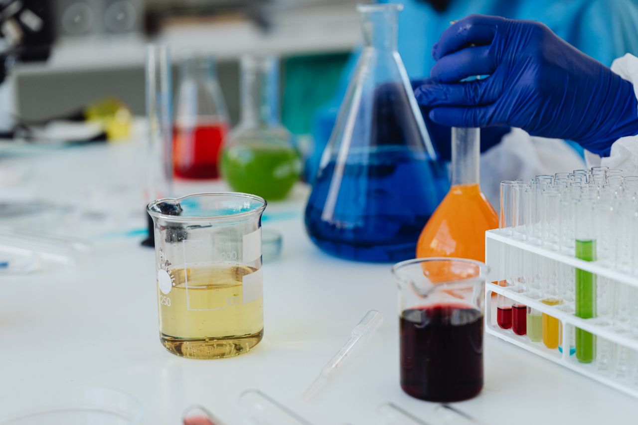 Home Colorful liquids in laboratory glassware and test tubes during a scientific experiment.